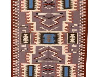 184
A Navajo Storm Pattern rug
Mid-20th century, Diné
Woven in brown, blue, lavender, deep red, orange, and cream wool, depicting an elaborate storm pattern and feather motifs
40" H x 29.75" W
Estimate: $300 - $500