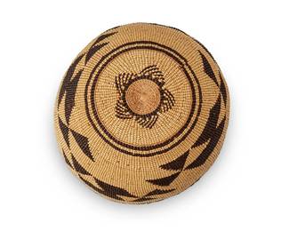137
A Hupa/Yurok/Karuk polychrome basketry hat
Early 20th century
Signed to interior: I.Natt
The twined hat with imbricated dark brown banded stripe and geometric motifs
3.625" H x 6.875" Dia.
Estimate: $400 - $600