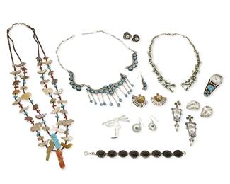 369
A large group of Southwest-style jewelry
Late 20th century
Variously marked for maker and for sterling; four marked for Mexico
Twelve works comprising a double strand carved stone fetish necklace, a silver and set turquoise
necklace with paper clip chain, and a Mexican silver feathered serpent necklace with malachite stone inlay, a turquoise set watch cuff bracelet and a black stone link bracelet, as well as one single earring and six further pairs of silver and mixed metal earrings, including a pair of Kit Carson 1990 sterling silver tableau earrings with leaping hares, and a signed sterling silver stylized Kokopelli brooch, 18 pieces
Necklaces: 28" L to 18 1/4" L; bracelets: 8 3/8" L and 6 1/8" inner C ; earrings: 3" H to 1" H
351.8 grams gross
Estimate: $400 - $600