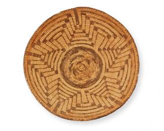 155
An Akimel O'odham/Pima basket
Early 20th century, Akimel O'odham; Southwest United States
The coiled wide basketry bowl with brown central optical radiating star motif
6" H x 15.75" Dia.
Estimate: $800 - $1,200