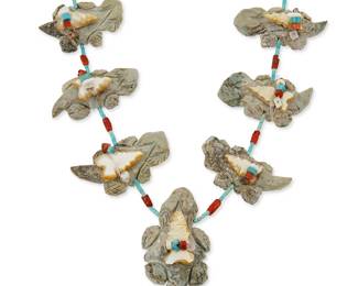 329
A Louise Singer Zuni carved stone "horny toad" fetish necklace
Late 20th century
With seven chunky carved stone horned toads, each with bound offer bundles, on a coral and turquoise heishi strand, with a silver cone clasp
24 1/4" L x 2 1/4" H
132.4 grams gross
Estimate: $200 - $400