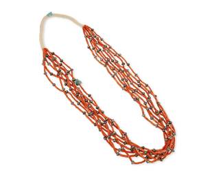 315
A Southwest Pueblo coral and silver necklace
Mid/late 20th century
An eight-strand necklace of tubular coral beads with a single turquoise tab accent, separated by silver bead spacers and with a traditional wrapped neck cord
32" L
146.5 grams gross
Estimate: $400 - $600