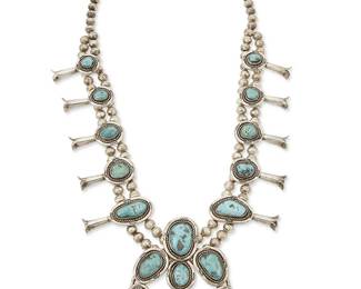 300
A Southwest silver and turquoise squash blossom necklace
Mid/late 20th century
Unmarked
A chunky sterling silver necklace with large central set turquoise naja and ten blossoms, each stone with rope twist and stampwork edging, all suspended from a double strand of silver beads
25" L x 2 3/8" H
166.0 grams gross
Estimate: $700 - $900