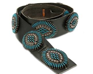 270
A Southwest Zuni-style sterling silver needlepoint concho belt
Late 20th century
Stamped to buckle: LH / Sterling
Comprising a large oval buckle with set needlepoint block turquoise and curled silver accents, together with nine matching conchos, all mounted to a wide black leather strap
Buckle and each concho: 2 1/4" H x 2 7/8" W; strap: 41.5" L x 2" H
409.5 grams gross
Estimate: $800 - $1,200