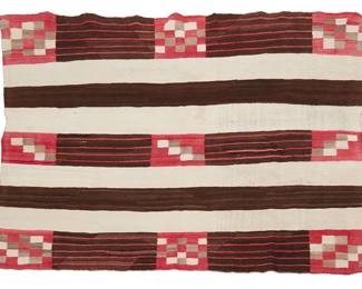174
A Navajo Second Phase wearing blanket
Late 19th century, Diné
Woven in red, brown, cream, and grey wool, depicting banded and checkered motifs
69" H x 48" W
Estimate: $2,000 - $4,000