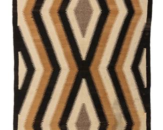 193
A Navajo regional rug
Mid-20th century, Diné
Woven in dark brown, tan, cream, and grey/brown wool, depicting a simplified eyedazzler with two central radiating sawtooth diamonds
72.5" H x 44" W
Estimate: $500 - $700