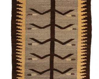 190
A Navajo pictorial runner
Mid-20th century, Diné
Woven in dark brown, cream, tan, light brown, and natural grey/brown wool, depicting a central corn stalk with stepped border at two long edges
67" H x 31" W
Estimate: $500 - $700