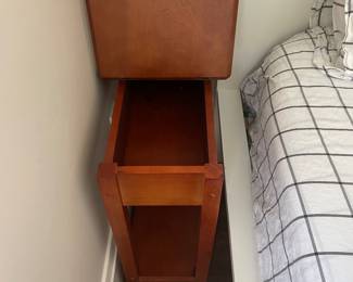 Bedside table shown with the top open to see the storage available