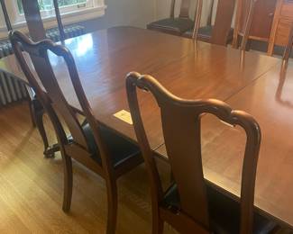 $980 Vintage Baker dining table with three leaves and pads includes 10 chairs. The chairs are upholstered with leather seats. The table measures 55.5 inches long (with one 18” leaf) 44 inches wide by 29 inches high. Available for online purchase.