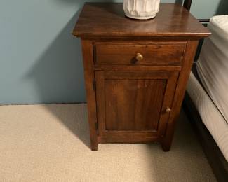 $240 for a pair of Pottery Barn solid wood bedside tables with one drawer and cupboard door. 19 inches wide by 16 inches deep by 27 inches high. Available for online purchase.