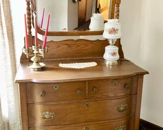 Antique dresser w/ attached wooden mirror, vintage lamp, candle holder
