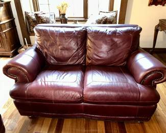 Close-up view of chocolate brown leather loveseat
