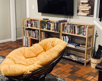 Large Papasan Chair. 46". 55" Sony Smart TV. Large Selection of Books and Coffee Table Books.