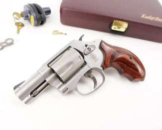 Make: Smith & Wesson
Model: 60-14 Lady Smith
Caliber: .357 Magnum
Action: DA
Barrel: 2
Bore: Shiny
Serial # CFM3372
Condition: Great
Smith & Wesson Ladysmith Model 60-14 .357 Mag Revolver with Factory Case. A stainless steel development of the Smith & Wesson Model 36 Chief's Special revolver, the Model 60 has a swing-out cylinder, and features an exposed hammer. It has been in production since 1965, and was the first regular production all stainless steel firearm made. The 1965 model's stainless steel production proved so popular that there was a waiting list at gun shops for up to six months to purchase one. Suitable for small hands, this Smith & Wesson features ergonomic wood grip and a 2.125-inch barrel. The handgun holds up to 5 rounds and comes with a blade front sight and a fixed rear sight. Sold with factory Box. This Revolver is in excellent condition showing normal signs of use and wear. 