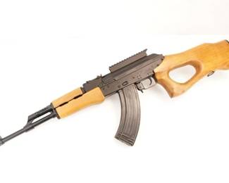 Make: FEG
Model: SA 85M
Caliber: 7.62x39
Action: Semi
Barrel: 16
Bore: Bright
Serial # SM08102
Condition: Excellent
Importer: K.B.I INC
The SA-85 is an AK-pattern rifle made by Fegyver És Gépgyár (F.E.G.) of Hungary. It was sold in a "sporting" configuration to get around U.S. gun laws at the time. It was also imported into the United States[where?]pre-ban[which?]in two variants, a solid thumbhole style stock and an underfolder stock that folded under the rifle. This rifle is a semi-automatic version of the Russian AK-47, with a strange thumb-hole butt-stock, helping to make it a legal hunting rifle in the United States. Chambered in 7.62 x39 and sold with one mag, this rifle is in very good condition, showing normal signs of use and wear. 