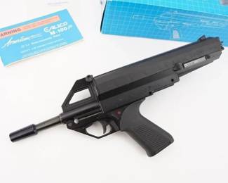 Make: Calico
Model: M-100P
Caliber: .22LR
Action: Semi
Barrel: 6.75
Bore: Bright
Serial # G006893
Condition: Great
The Calico M-100P is an American pistol developed in the late 1980s or early 1990s from the M-100. Considered by many to be a truly revolutionary design in the pistol caliber carbine market, the Calico M-100P features a helical feed magazine sitting atop the upper receiver. A rectangular torsion spring located inside the fluted cartridge carrier creates the driving pressure moving the rounds forward into a specially designed top-loading chamber. With a high capacity, this pistol feeds from a 100-round drum magazine. This pistol is sold with a factory box and paperwork. This pistol remains in Great condition showing normal signs of use and wear.