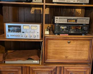 1980's stack stereo in wood cabinet includes: radio, tape player,turntable, CD player,