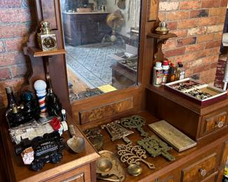 antique vanity, collectible Avon cologne bottles, cast iron trivets, vintage oil paint