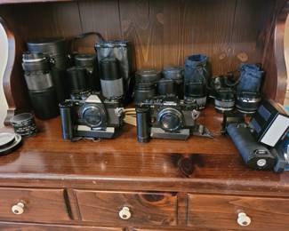 Three camera bodies and various lenses priced separately.