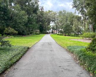 This is the driveway leading to the house. Please park in grass area on either side of the driveway . 