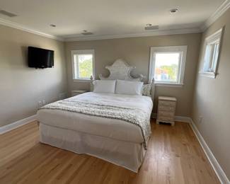 King Bedroom Set headboard has a carved bird accent