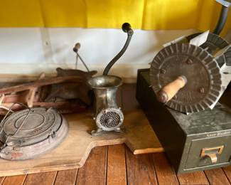 cast iron waffle griddle, meat grinder, file box and bun cutter