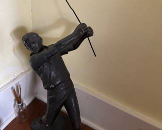small plaster sculpture of golfer