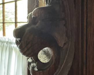 detail of lion on the curved glass cabinet