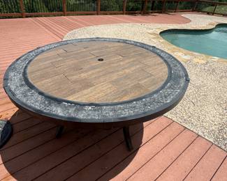 Large heavy round table with oversized umbrellas (2) 