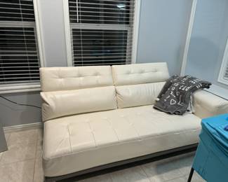Gorgeous cream leather sectional sofa in mint condition has storage on the arm and back, and can be attached or split to create two pieces (each sold separately).