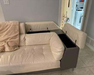 Gorgeous cream leather sectional sofa in mint condition has storage on the arm and back, and can be attached or split to create two pieces (each sold separately).