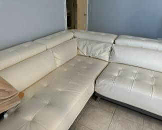 Gorgeous cream leather sectional sofa in mint condition has storage on the arm and back, and can be attached or split to create two pieces (each sold separately).