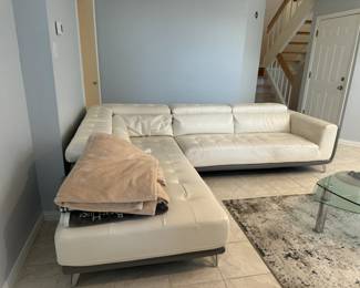 Gorgeous cream leather sectional sofa in mint condition has storage on the arm and back, and can be attached or split to create two pieces (each sold separately).