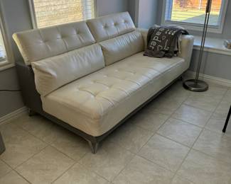 Gorgeous cream leather sectional sofa in mint condition has storage on the arm and back, and can be attached or split to create two pieces (each sold separately).