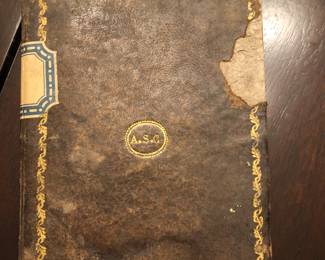 Back cover of antique book containing hand written manuscript of Baqashot songs $500