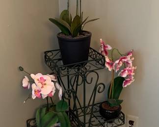 Artificial orchids and metal plant stand