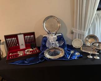 Nice collection of silver plate and Waterford crystal pieces.