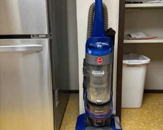 Hoover upright vacuum with booklet and attachments.