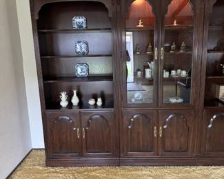 Cherry bookshelf with two-shelf covered storage and glass front lighted curio.