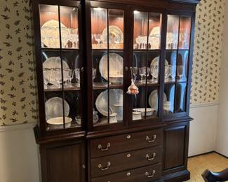 Ethan Allen Georgian Court two piece lighted china cabinet. Has size storage and three drawers, including a silver insert.