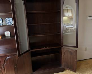 Cherry book/ curio shelf glass front with two shelf covered storage. 