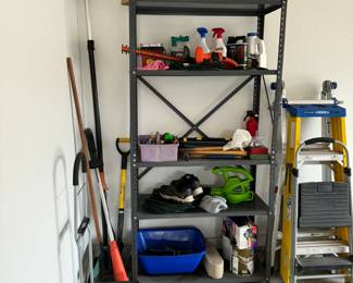 Garage items include hedge trimmers, painting supplies, a small dolly, step ladders and other lawn care equipment.