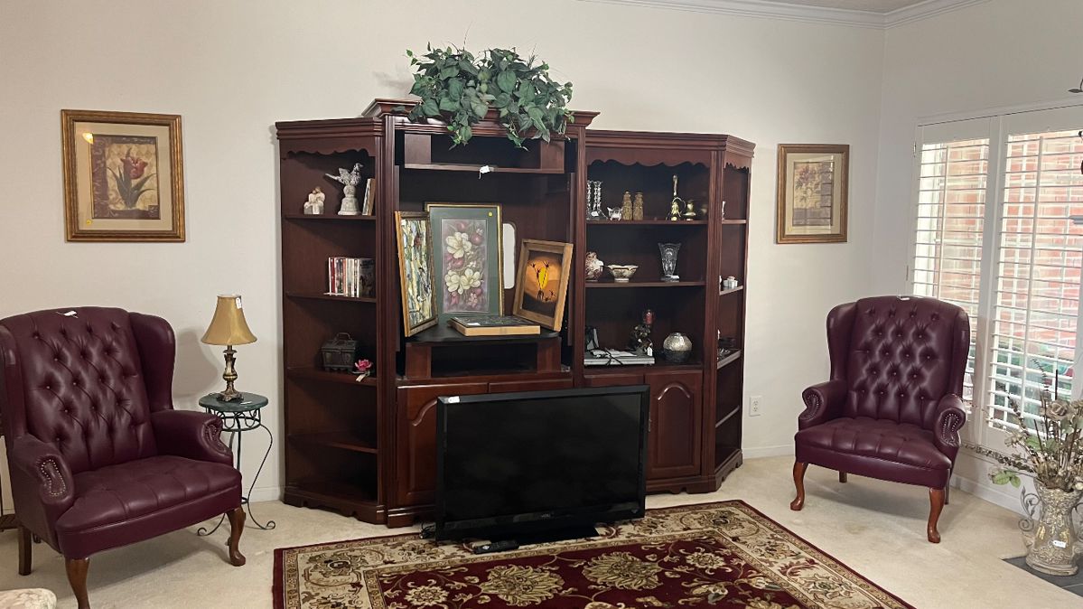 Large entertainment center, Vizio tv, 2 leather side chairs and decor