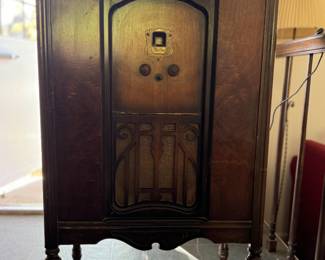Vintage Silvertone radio in wooden console cabinet with original tubes and speaker. 