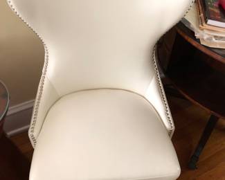 One of a pair of white chairs