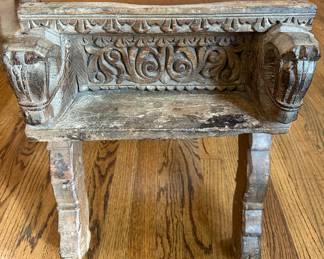 Antique wood and leather stool with carved details