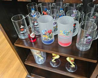 Several glass mugs from Disney with Mickey and Minnie and Donald...