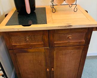 Looks like a bar.  The empty wine rack looks familiar.  Never can keep it full.  Not talking about the other object and scared to push the blue button.