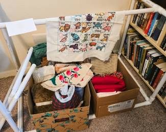 Quilt frame and unfinished needlepoints 