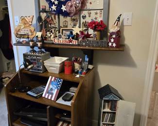 small desk with pull out keyboard drawer, window mirror, CDs and office supplies